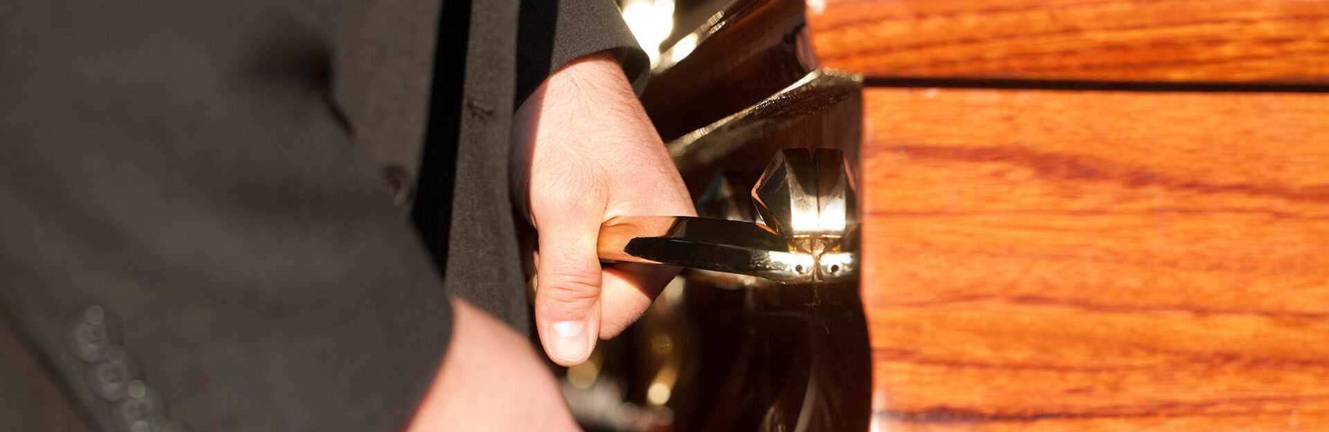 A man holding a handle on a casket