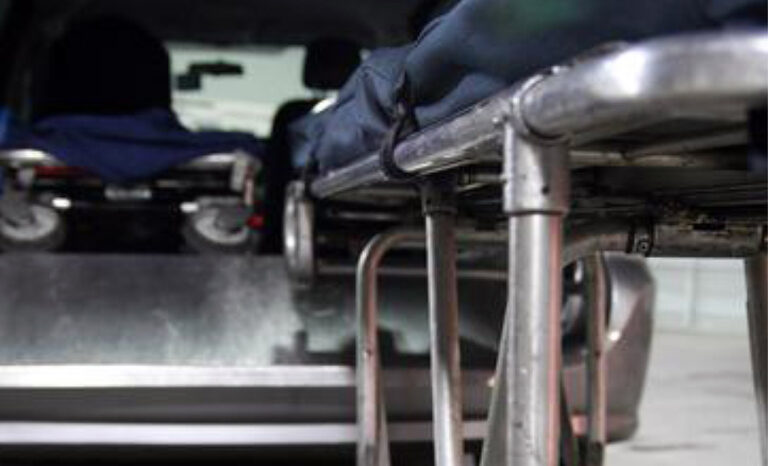 Loading cot on Link mortuary deck