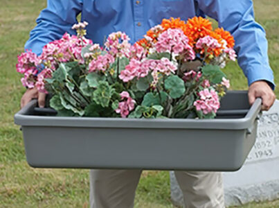 Man transporting flowers in FT2234 flower tray